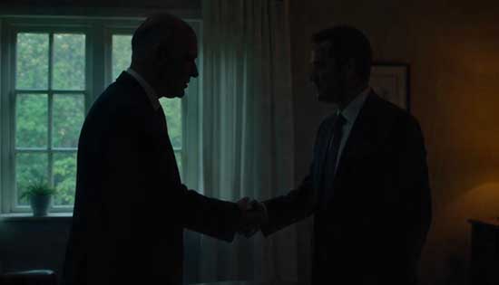 Two professionals shaking hands in a formal and respectful manner